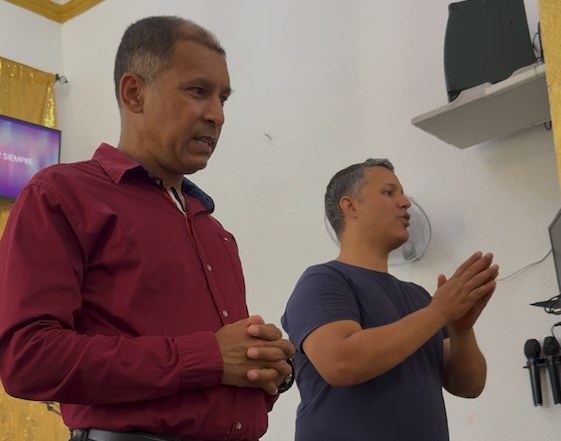 Pastor Luis Barbosa and Charlie Coe talking inside the church